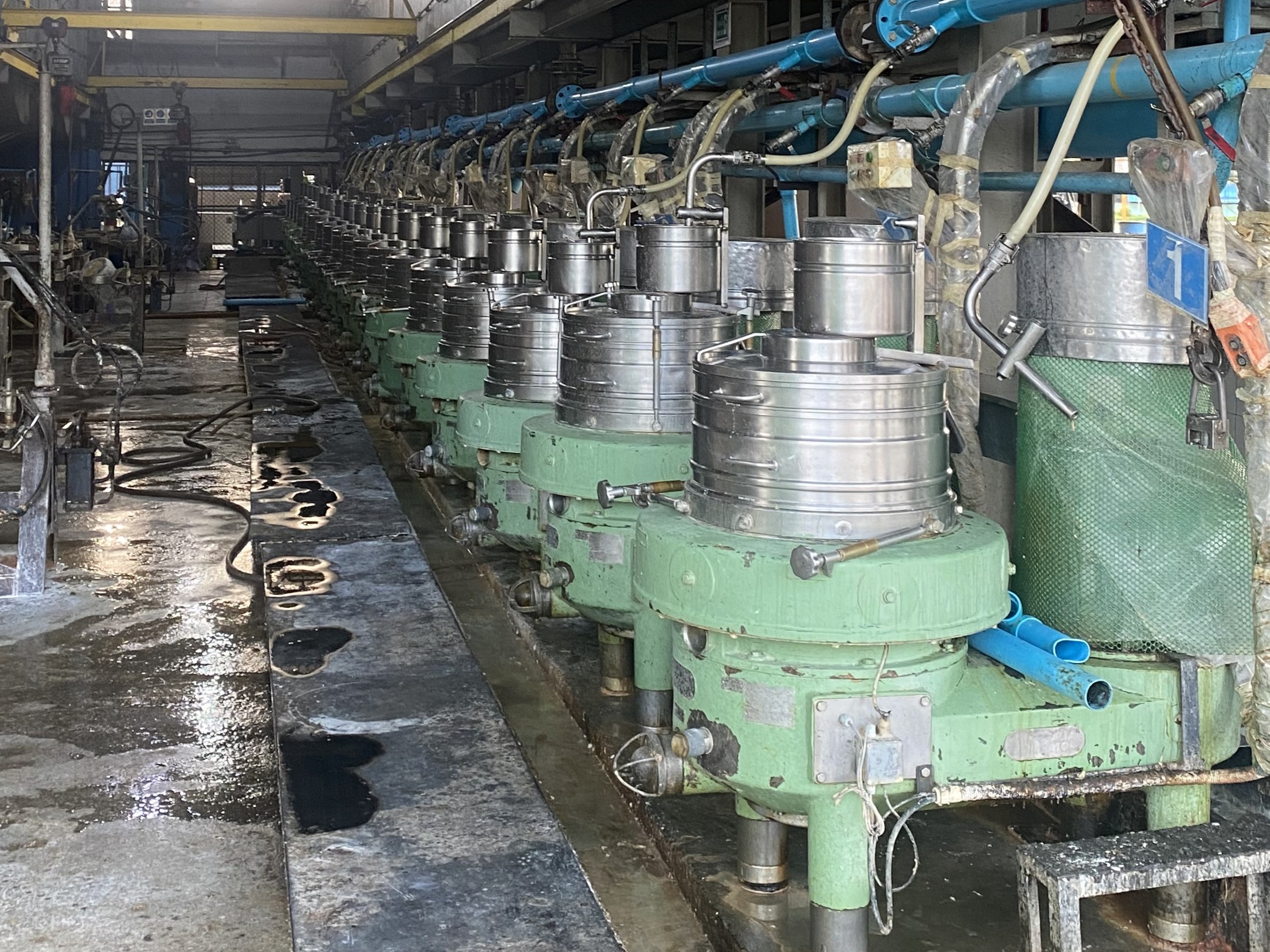 Centrifuge machines used to remove water from processed natural rubber in a manufacturing facility